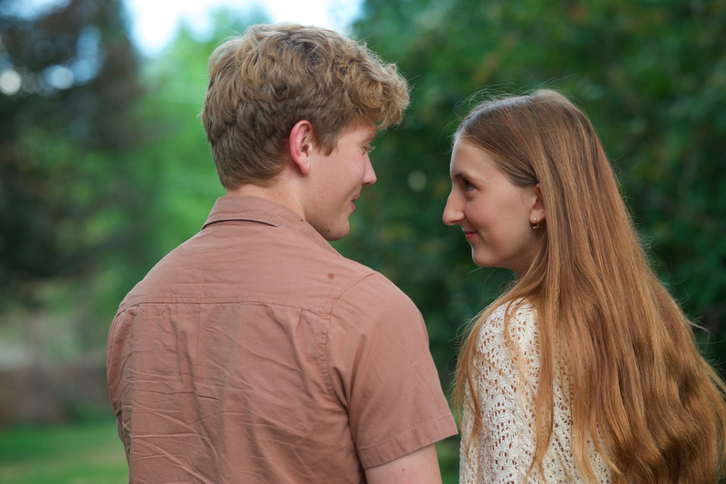 Molly and Tyler smiling at each other in a garden