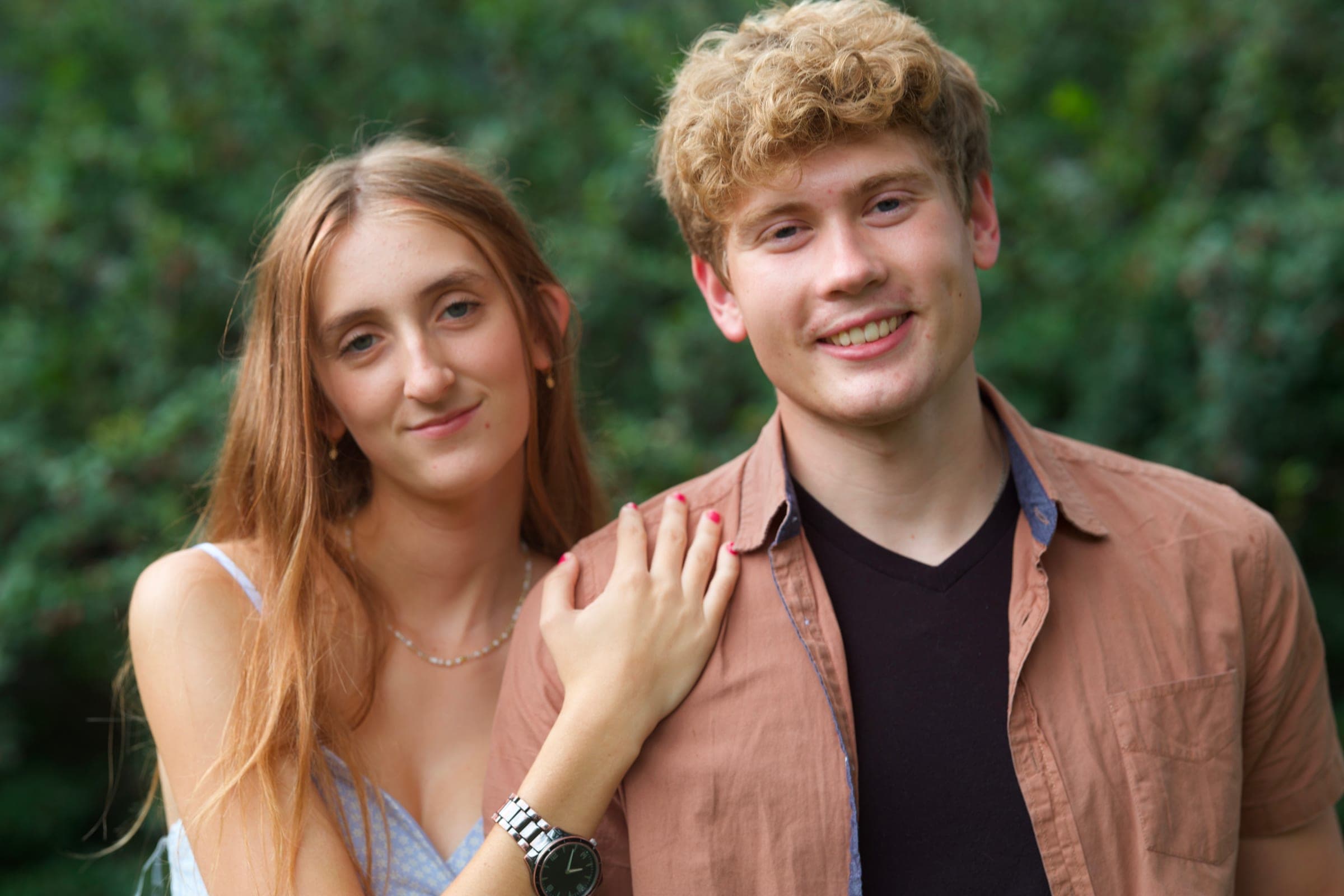 Molly with her hand on Tyler's shoulder, both smiling